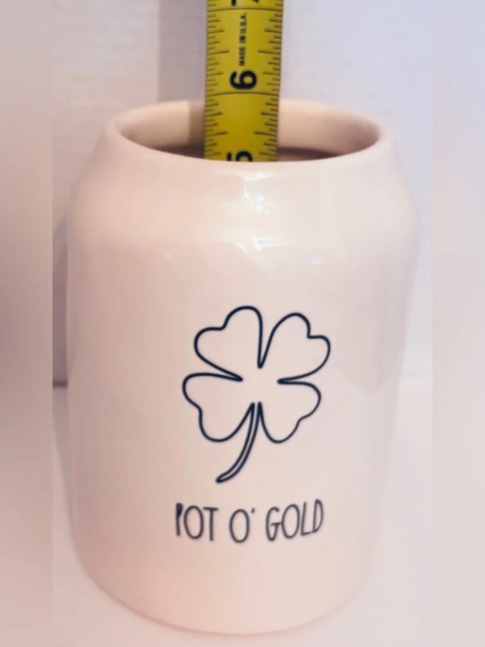 Rae Dunn off White Ceramic 'POT O’GOLD’ Canister with Green Handle covered lid.